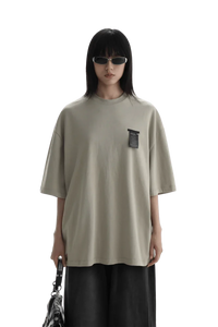 Masonprince WashTag Tee oversized beige shirt with black wash tag detail worn by model with sunglasses