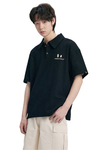 DangerousPeople DSP｜Textured Small‑Eye Graphic Boxy Fit Couple Short‑Sleeve Polo Shirt