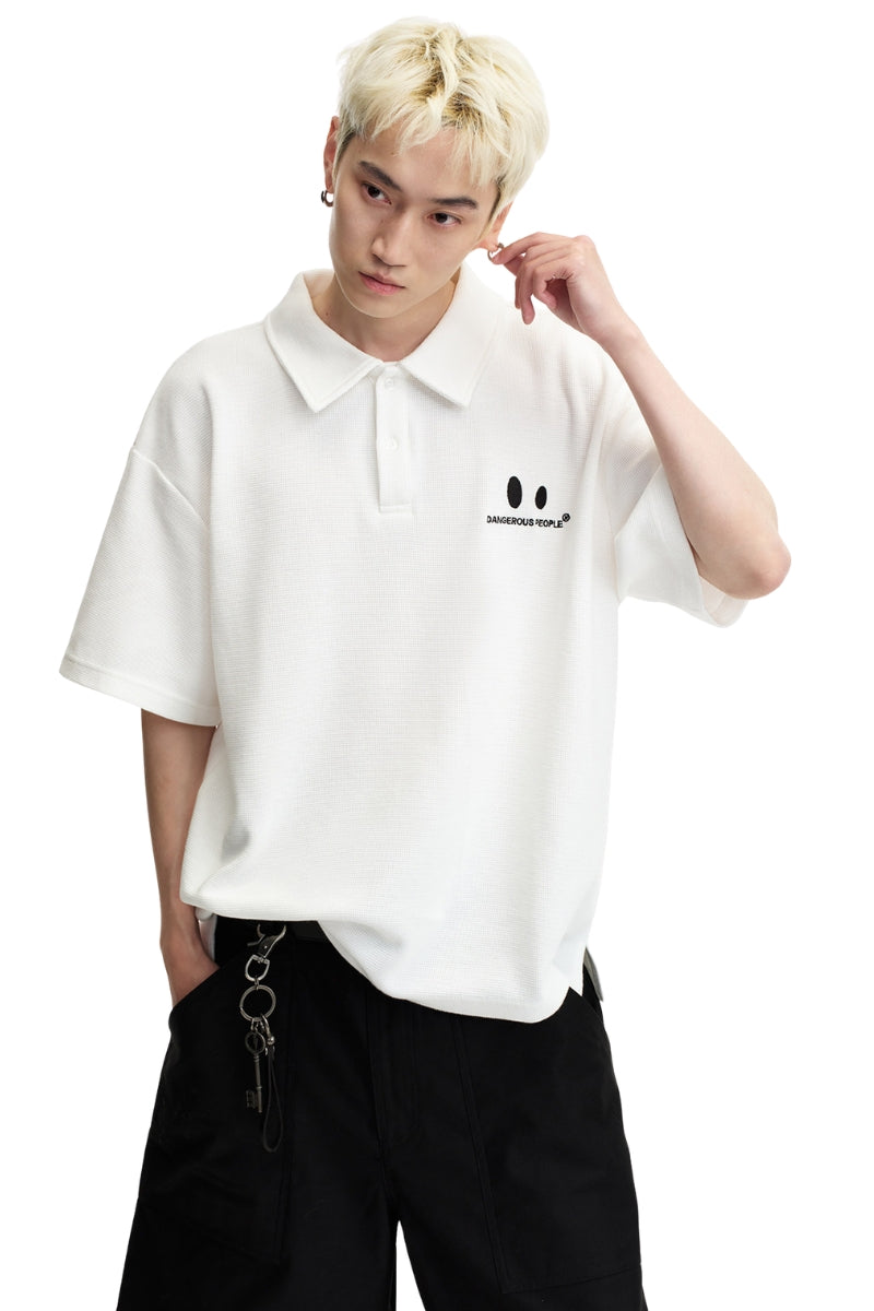 DangerousPeople DSP｜Textured Small‑Eye Graphic Boxy Fit Couple Short‑Sleeve Polo Shirt