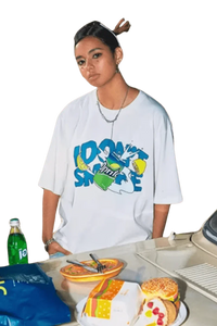 Woman wearing white IDontSmoke Drinks Series Tee with colorful graphic by a table with snacks and drinks