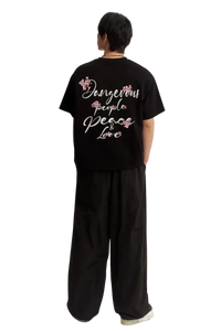 Black Cherry Blossom Tee by Dangerous People with floral designs and stylish text on the back
