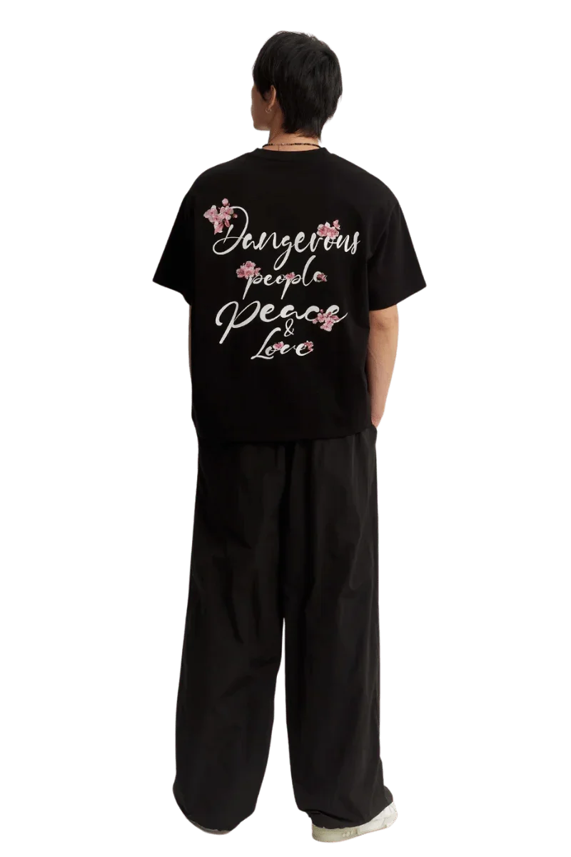 Black Cherry Blossom Tee by Dangerous People with floral designs and stylish text on the back