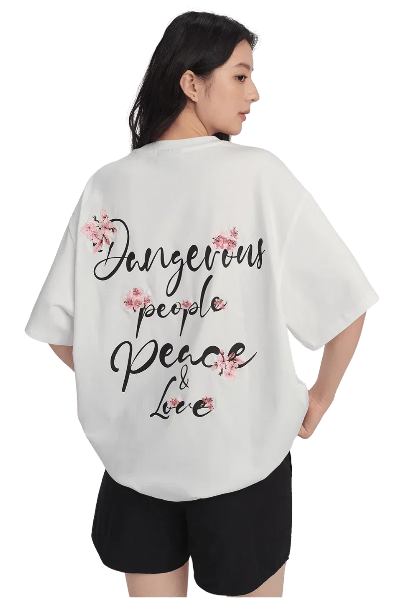 Cherry Blossom Tee from Dangerous People featuring floral design and positive message on a white background