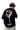 Back view of Dangerous People graphic tee featuring colorful artwork and brand logo on a black shirt