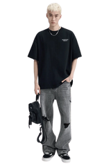 Dark oversized Dangerous People Ice Cube Tee paired with distressed gray jeans for a stylish look