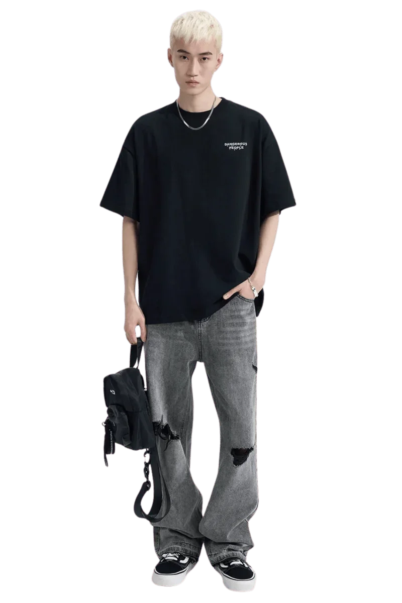 Dark oversized Dangerous People Ice Cube Tee paired with distressed gray jeans for a stylish look