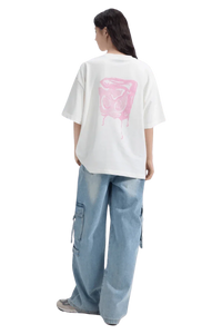Back view of a woman wearing the Dangerous People Ice Cube Tee with a pink graphic design on a white shirt