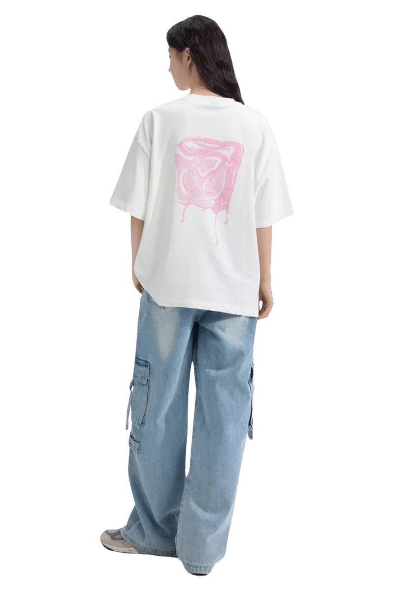Back view of a woman wearing the Dangerous People Ice Cube Tee with a pink graphic design on a white shirt