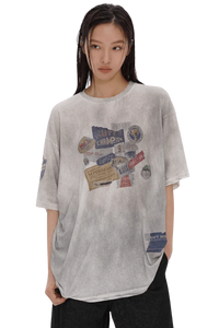 Masonprince Dirty 150GSM Tee in light gray with vintage graphic patches worn by model