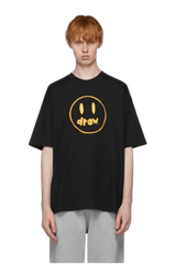 Drew House Painted Mascot Tee in black with yellow smiley logo for casual fashion.