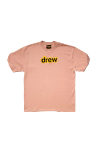 Drew House Secret SS Tee in soft pink featuring bold yellow 'drew' logo on the front