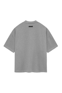 Back view of SS24 Heavy Jersey Arch Logo Tee by Fear Of God Essentials in gray color