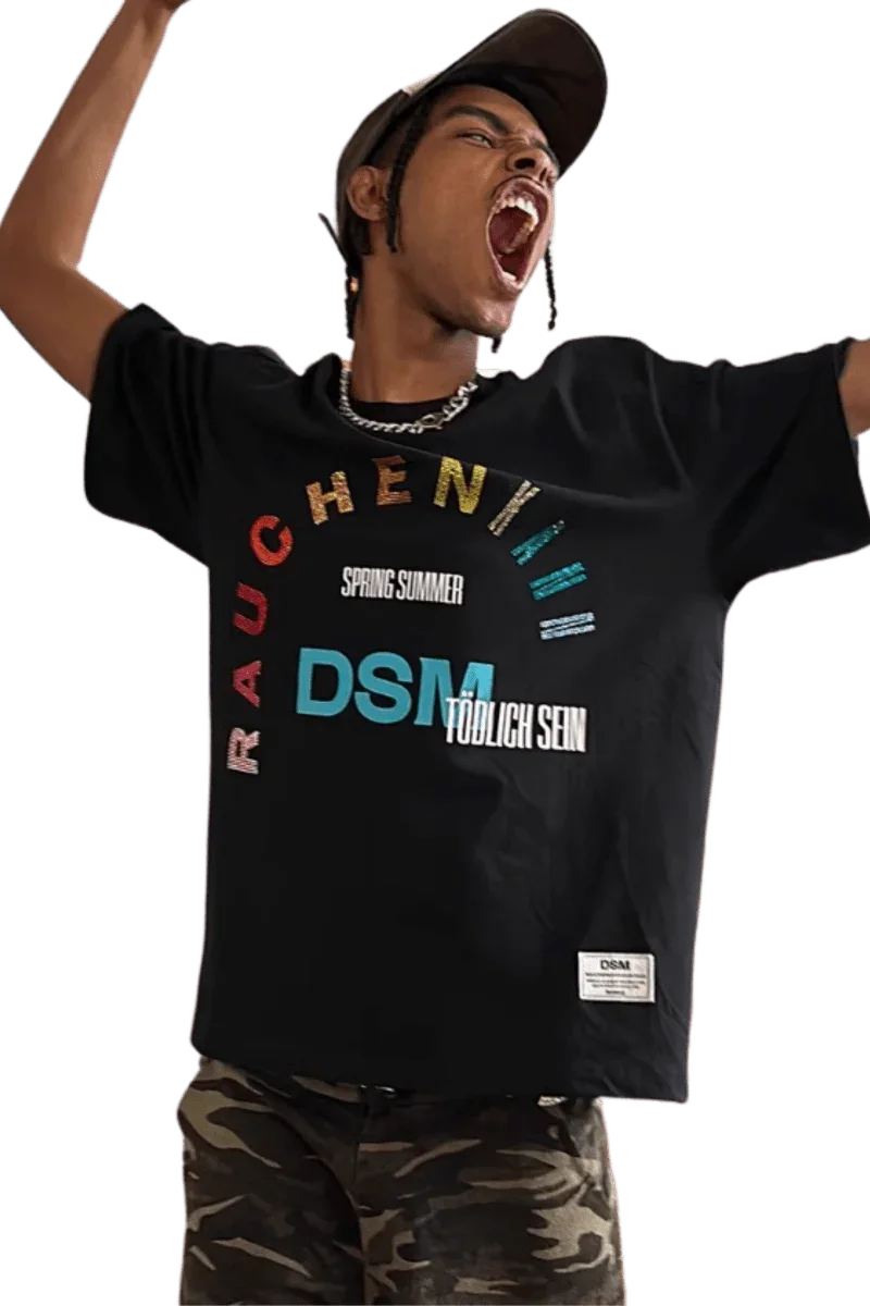 IDontSmoke SS25 Arch Logo Rhinestone Tee black graphic t-shirt worn by excited man with camo pants