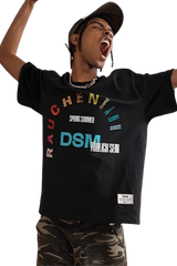 IDontSmoke SS25 Arch Logo Rhinestone Tee black graphic t-shirt worn by excited man with camo pants