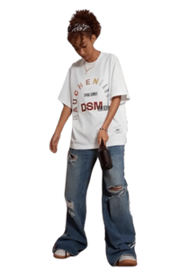 Model wearing IDontSmoke SS25 Arch Logo Rhinestone Tee white oversized graphic t-shirt with distressed blue jeans