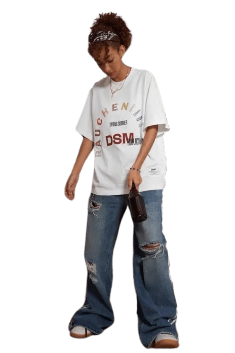 Model wearing IDontSmoke SS25 Arch Logo Rhinestone Tee white oversized graphic t-shirt with distressed blue jeans