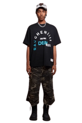 Model wearing IDontSmoke SS25 Arch Logo Tee black graphic t-shirt paired with camo cargo pants and black boots