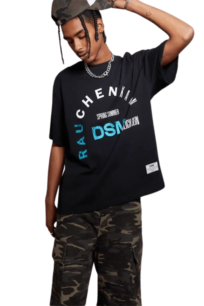 IDontSmoke SS25 Arch Logo Tee black graphic t-shirt worn with camo pants and hat