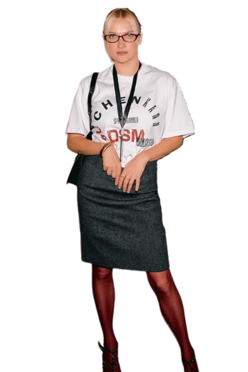 Woman wearing IDontSmoke SS25 Arch Logo Tee white graphic t-shirt styled with gray skirt and red tights