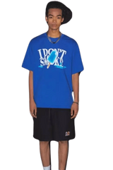 Model wearing a blue IDontSmoke Street Picnic Series Tee with black shorts on black background
