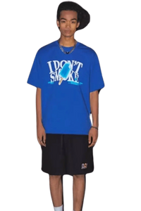 Model wearing a blue IDontSmoke Street Picnic Series Tee with black shorts on black background