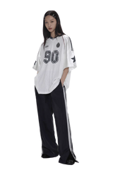 Masonprince 90s star mesh tee white oversized shirt with black numbers worn by model with black pants