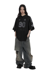 Masonprince 90s star mesh tee in black with number 90 print worn with distressed wide-leg jeans