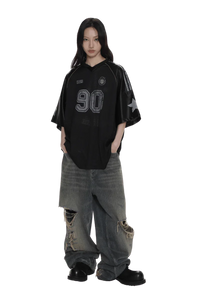 Masonprince 90s star mesh tee in black with number 90 print worn with distressed wide-leg jeans