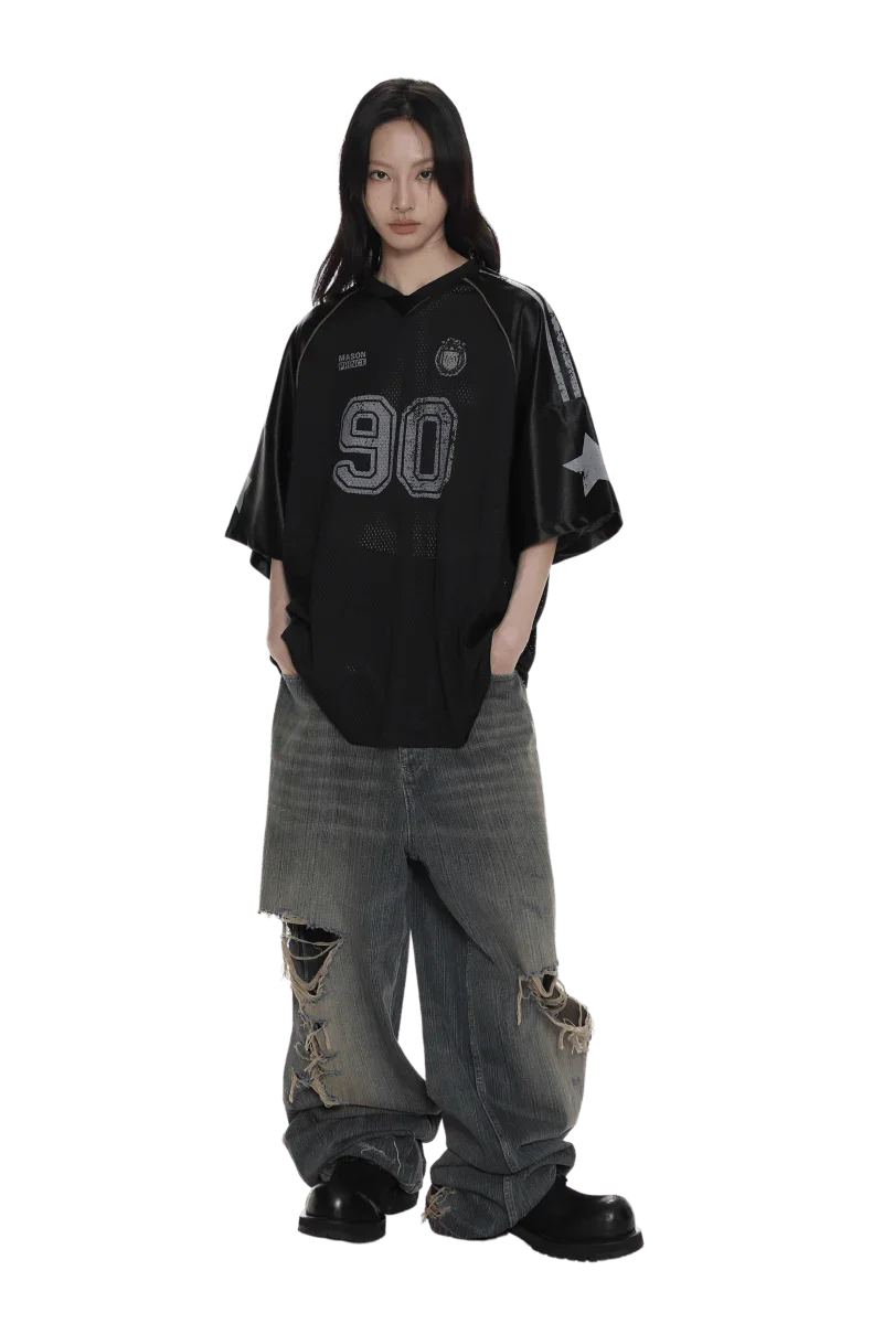 Masonprince 90s star mesh tee in black with number 90 print worn with distressed wide-leg jeans
