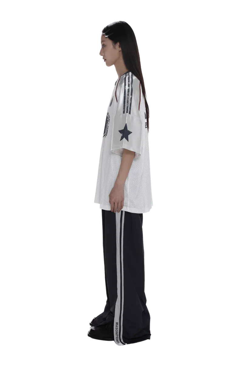 Side view of model wearing Masonprince 90s star mesh tee with star and stripe details on sleeves