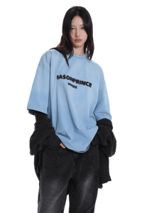 Model wearing Masonprince 2.0 Faded Logo Gradient Tee in light blue with black text and relaxed fit