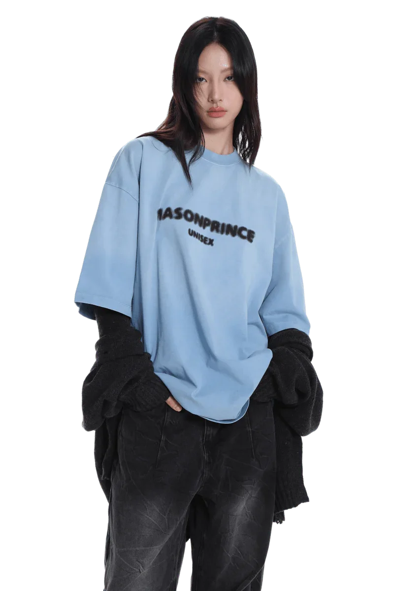 Model wearing Masonprince 2.0 Faded Logo Gradient Tee in light blue with black text and relaxed fit