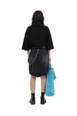 Back view of model wearing Masonprince 808 Breathe Tee in black with denim skirt and holding blue bag