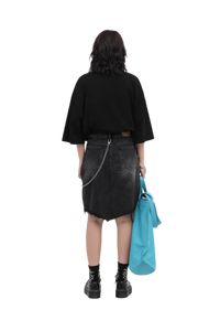 Back view of model wearing Masonprince 808 Breathe Tee in black with denim skirt and holding blue bag
