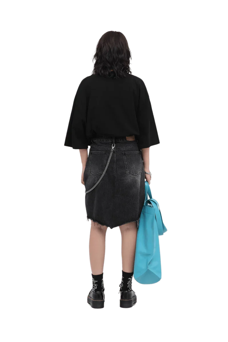 Back view of model wearing Masonprince 808 Breathe Tee in black with denim skirt and holding blue bag