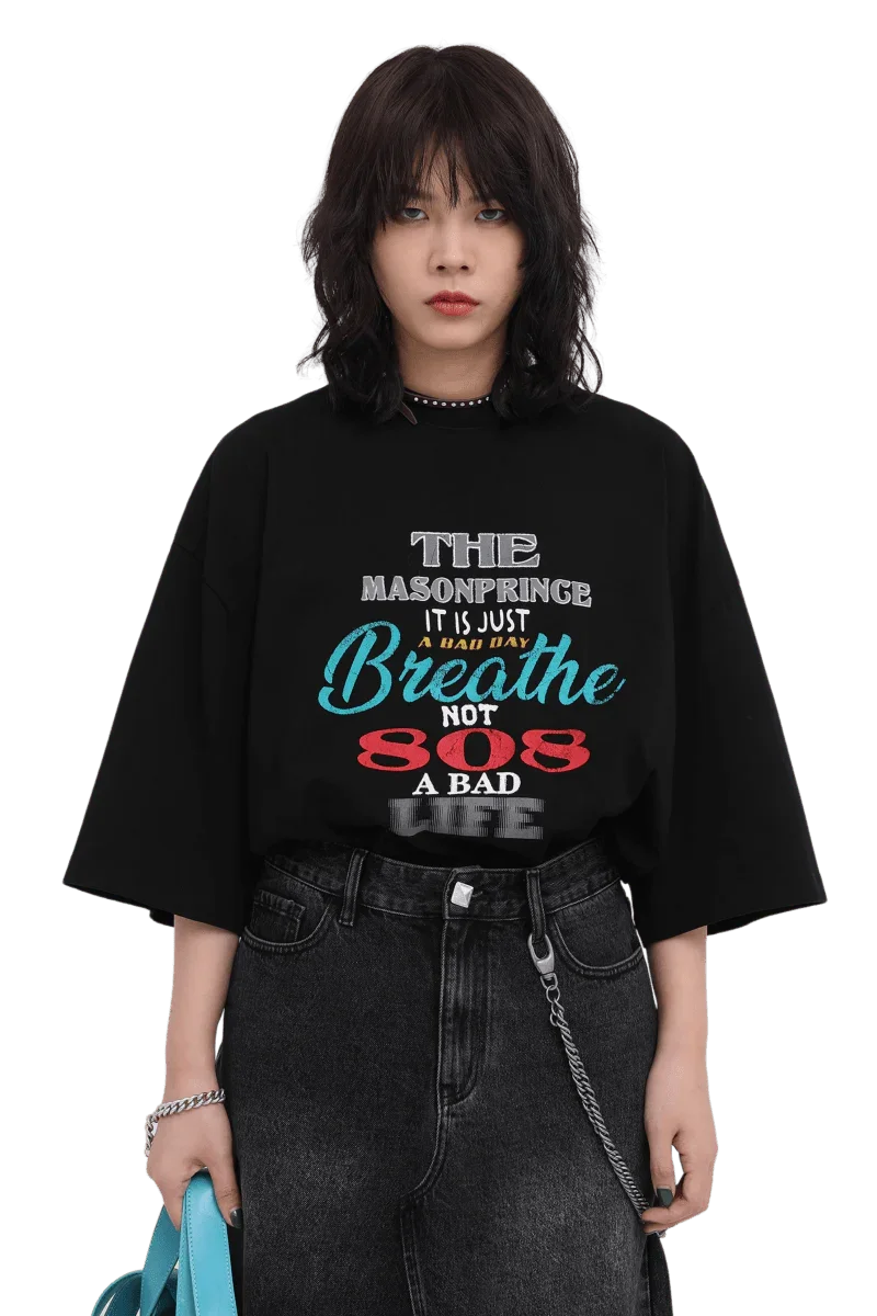 Masonprince 808 Breathe Tee black oversized shirt with colorful text worn with black jeans