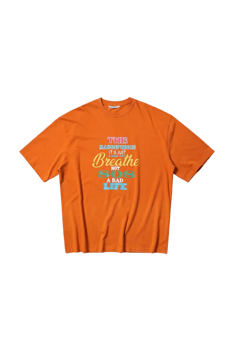 Orange Masonprince 808 Breathe Tee with motivational graphic text on front