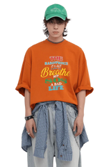 Masonprince 808 Breathe Tee in orange worn by model with green cap and layered casual outfit