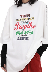 White Masonprince 808 Breathe Tee with colorful text design worn with black sleeves and red pants