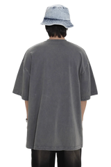 Back view of person wearing oversized Masonprince 88 t-shirt in faded gray with short sleeves and bucket hat