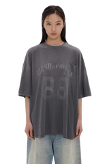 Masonprince 88 t-shirt in faded black with printed logo and pocket worn by female model