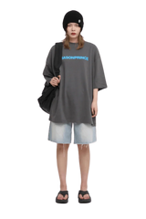 Masonprince Basic Logo Tee in gray with bold blue text, paired with denim shorts and sandals