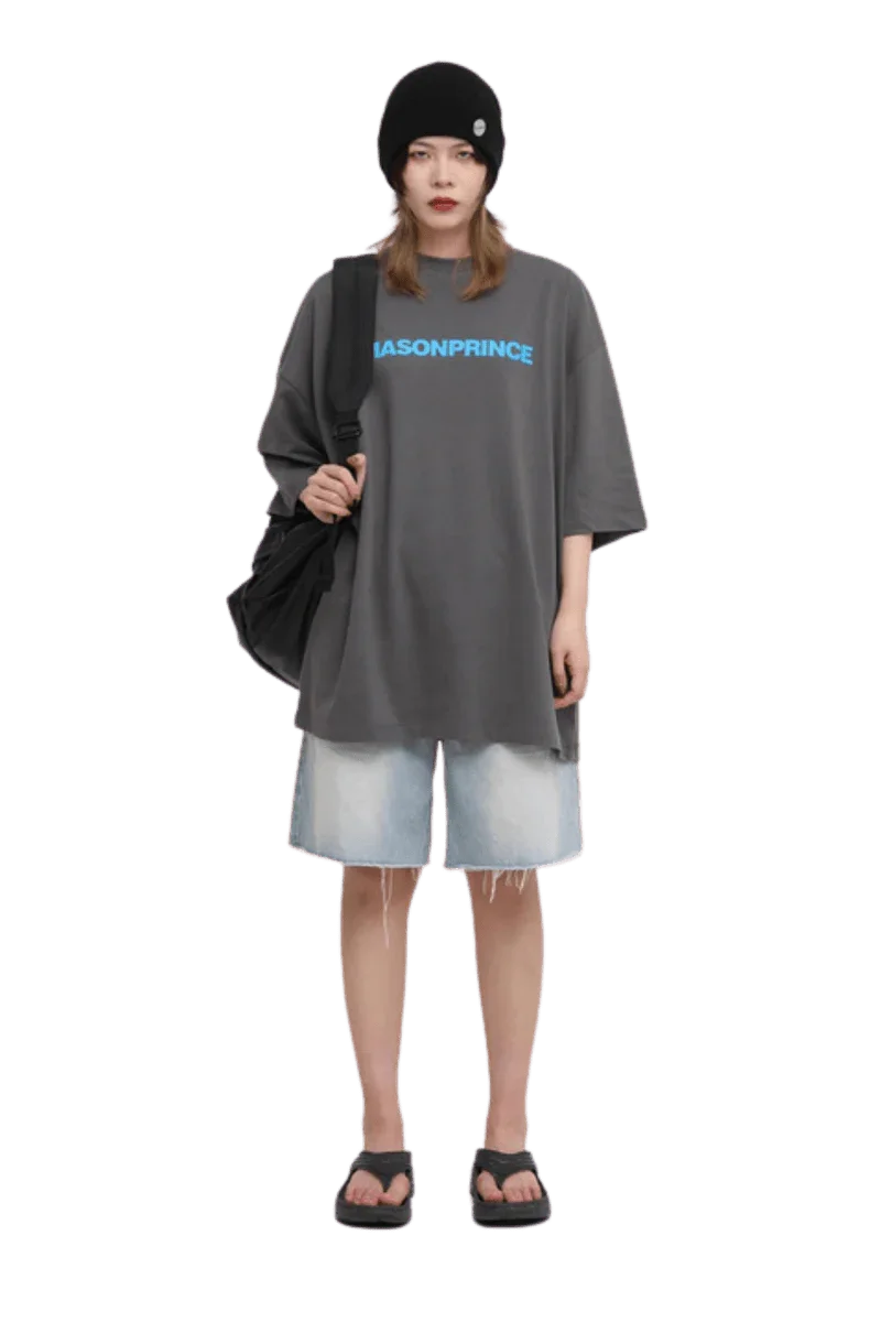 Masonprince Basic Logo Tee in gray with bold blue text, paired with denim shorts and sandals
