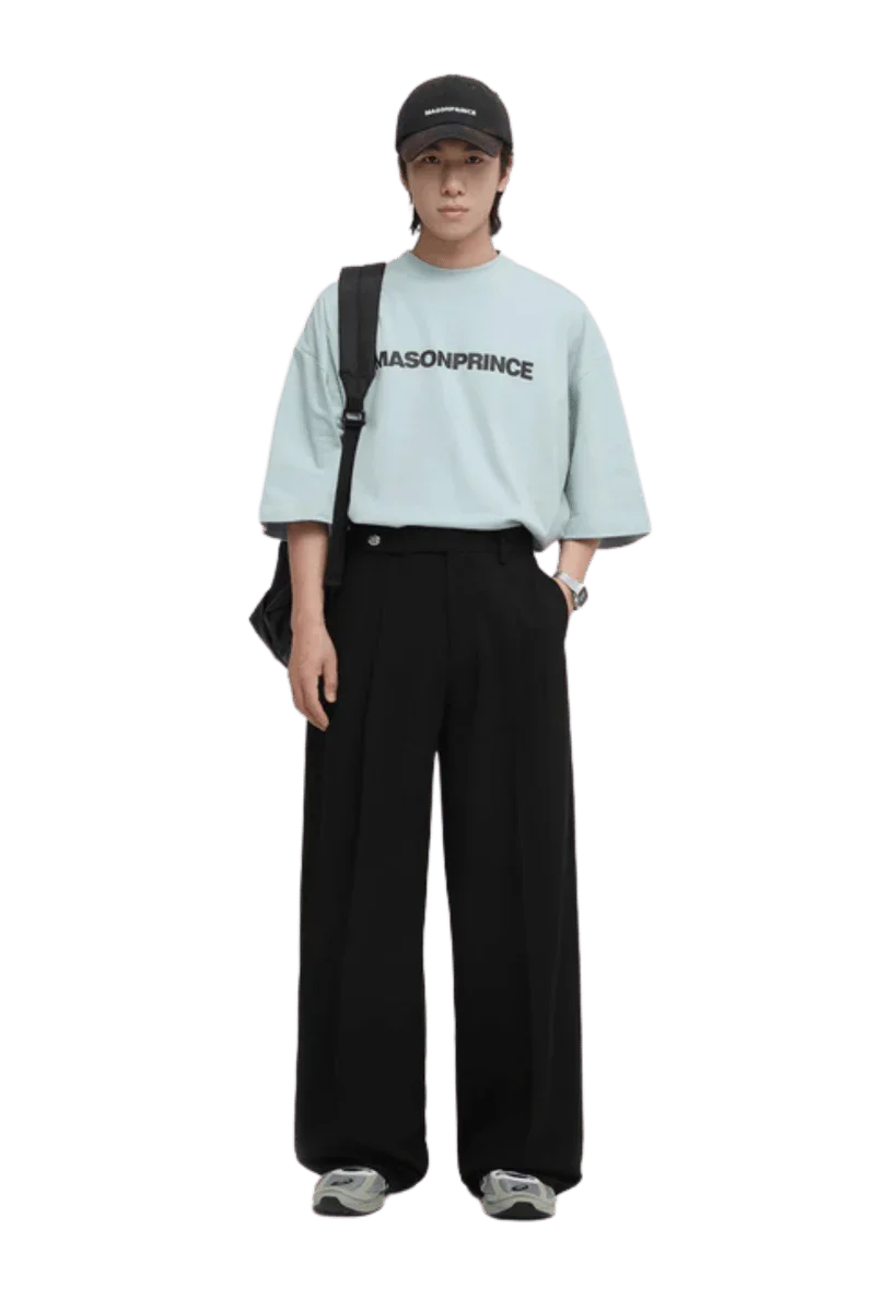 Model wearing Masonprince Basic Logo Tee in light blue with relaxed fit and black wide-leg pants
