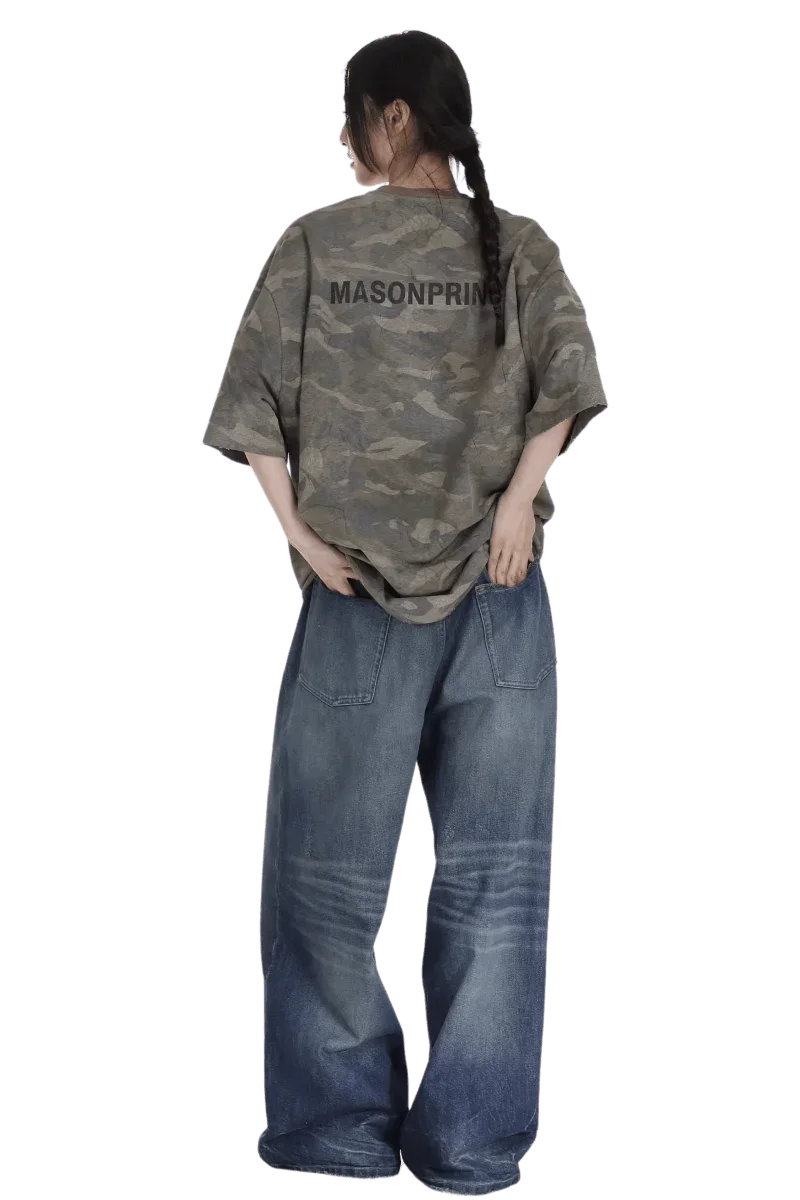 Back view of a woman wearing a Masonprince camouflage tee paired with wide-leg blue jeans