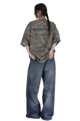 Back view of a woman wearing a Masonprince camouflage tee paired with wide-leg blue jeans