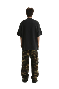 Back view of a man wearing Masonprince Champion League Tee with cargo pants in a casual style