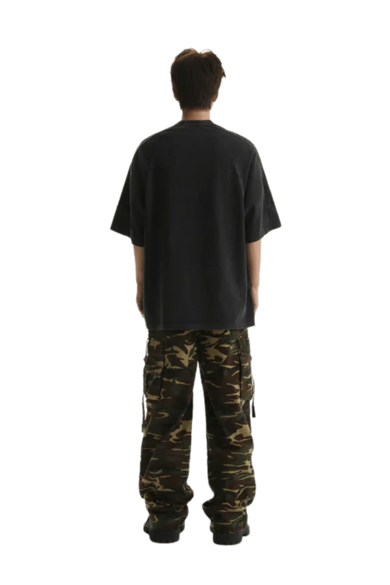 Back view of a man wearing Masonprince Champion League Tee with cargo pants in a casual style