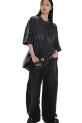 Model wearing Masonprince Champion League Tee black oversized shirt with bag and wide black pants