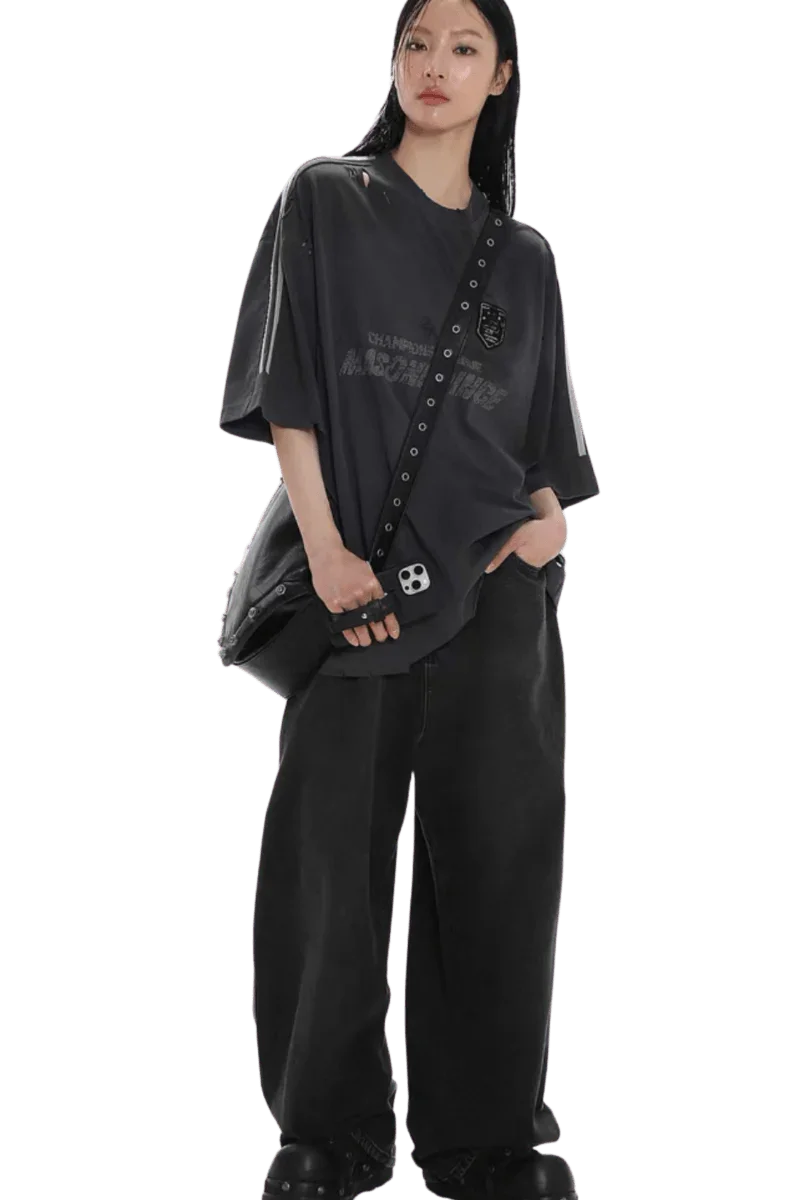 Model wearing Masonprince Champion League Tee black oversized shirt with bag and wide black pants